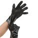 A person wearing Cordova black PVC gloves with jersey lining.