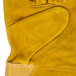 A close up of a yellow and russet Cordova warehouse glove.