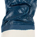 A blue Cordova warehouse glove with white jersey lining and a white safety cuff.