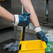 A person wearing Cordova smooth supported nitrile gloves with jersey lining and safety cuffs holding a yellow bucket.