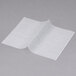 Durable Packaging interfolded deli wax paper on a gray surface.
