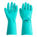 A pair of green unlined rubber gloves with a Cordova label.