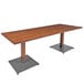 A Lancaster Table & Seating rectangular wooden table with metal legs.
