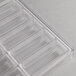 A clear plastic tray with rows of small rectangular compartments.