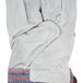 A pair of Cordova leather work gloves with a blue striped canvas cuff.