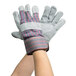 A pair of Cordova warehouse gloves with gray and blue stripes.