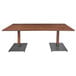 A Lancaster Table & Seating solid wood dining table with metal legs.
