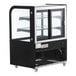 An Avantco black curved glass dry bakery display case on wheels with two shelves.