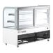 A white Avantco curved glass dry bakery display case with two shelves on wheels.