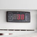 A digital temperature display on a white Avantco countertop display refrigerator.