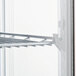 A white shelf with a metal rack inside an Avantco countertop display refrigerator.