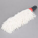 A white mop with a red handle on a grey surface.