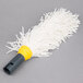 A white mop with a yellow handle.