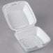 A Dart white styrofoam takeout container with a hinged lid.