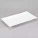 A 16 1/4" x 9" bright white rectangular porcelain platter on a gray surface.