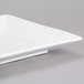A close-up of a 16 1/4" x 9" bright white rectangular porcelain platter with a small handle.