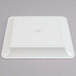 A white square Fineline plastic catering tray with a circle in the center.