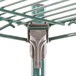 A Metroseal 3 wire shelving unit with 4 green metal shelves and metal poles.