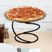 A pepperoni pizza on an Acopa black metal display stand.