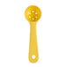 A yellow plastic spoon with holes.