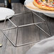 A metal frame with a pizza on it.