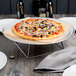 An Acopa stainless steel square display stand with a pizza on a plate.