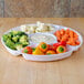 A Fineline white plastic 5-compartment tray with bowls of carrots and peppers on it.