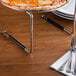 A pizza on a plastic stand.