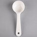 A white plastic Carlisle Measure Misers portion spoon.