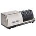 An Edgecraft Chef's Choice 2100 knife sharpener with three knives on it.