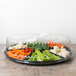 A Fineline black plastic 7-compartment tray with vegetables inside.