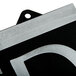A close up of a black and silver metal Headline Sign with "Open" and "Closed" on it.