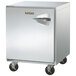 A stainless steel Traulsen undercounter freezer with black wheels and a left hinged door.