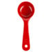 A red plastic Carlisle portion spoon with a handle.