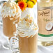 Two glasses of coffee with whipped cream and DaVinci Gourmet All-Natural Coconut Flavoring Syrup.