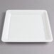 A white Fineline square plastic catering tray with a white circle in the middle.