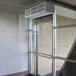 A glass door with a Curtron low profile air curtain over it.
