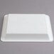 A white plastic rectangular Fineline Cater Tray with a circular pattern on it.