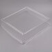 A clear plastic container with a clear plastic square dome lid.