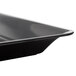 A close-up of a Fineline black plastic rectangular catering tray.