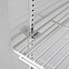 A white shelf with metal rods inside a Horizon Series reach-in refrigerator.