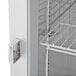 A metal shelf in a Beverage-Air Horizon Series reach-in freezer with a white door and metal handle.
