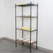 A 360 Office Furniture black wire shelving unit with books and papers on the shelves.