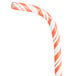 A close up of a Creative Converting jumbo paper straw with orange and white stripes.