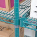 A blue Metro Super Erecta wire shelf with boxes on it.