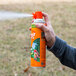 A person holding a SC Johnson OFF! outdoor fogger spray can