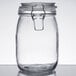 A 4 pack of clear glass Choice hinge top storage jars with metal lids.