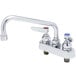 A T&S chrome deck-mounted workboard faucet with lever handles and a swing spout.