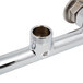 A chrome Equip by T&S wall mounted faucet base with supply elbows.