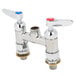 A chrome T&S deck mounted faucet base with lever handles and cerama cartridges.